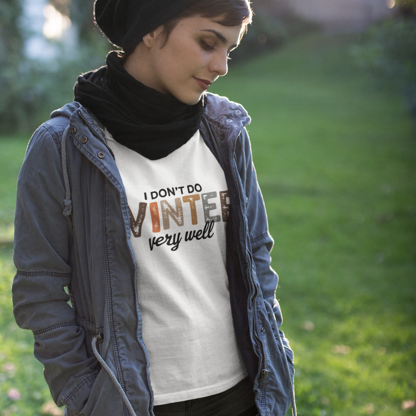 Person wearing a white t-shirt with text outdoors on a grassy background