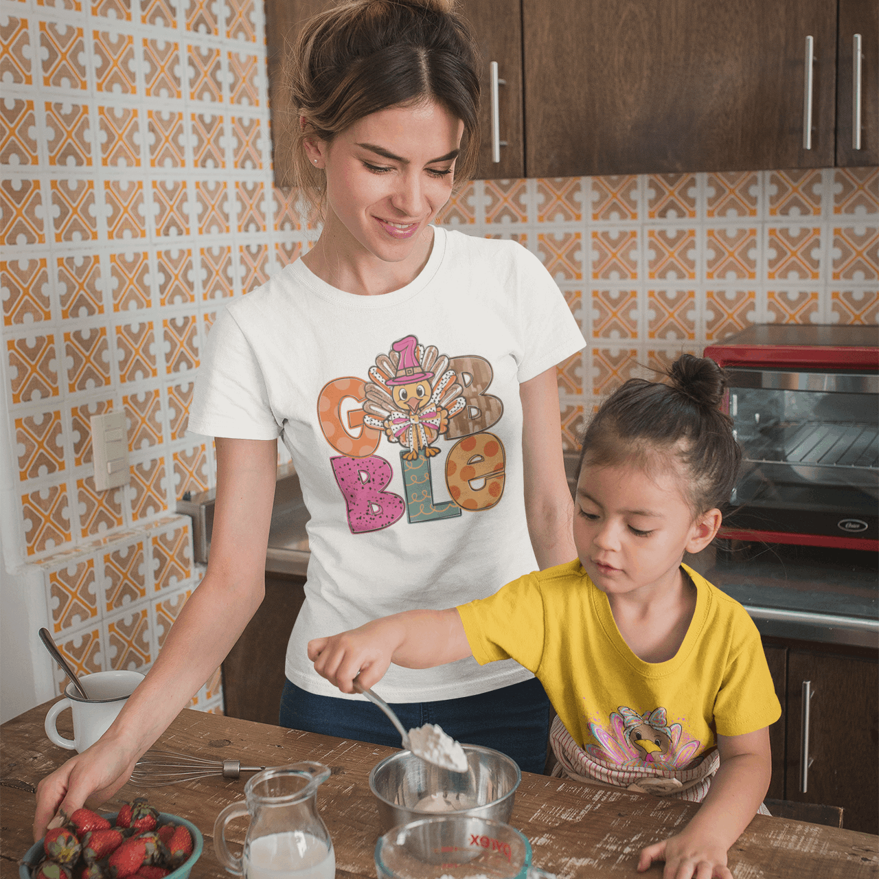 Woman and child in a kitchen preparing food together.