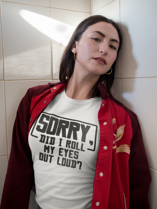 Person wearing a white t-shirt with text and a red jacket against a tiled wall.