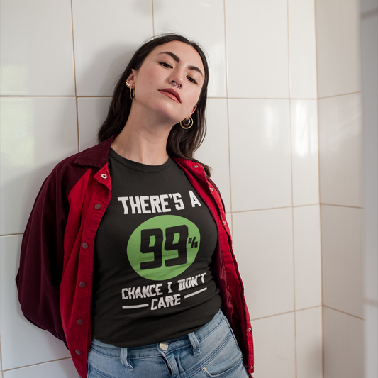 Person wearing a black t-shirt with a green graphic and text, standing against a tiled wall.