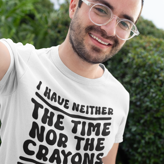 Man wearing a white t-shirt with a humorous text design outdoors.