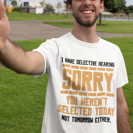 Man wearing a white t-shirt with humorous text outdoors