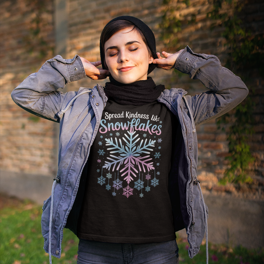 Person wearing a black t-shirt with a colorful snowflake design and text, standing outdoors.