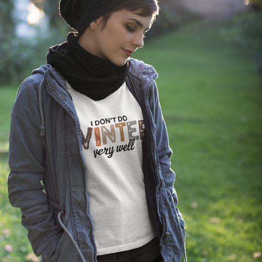 Person wearing a white t-shirt with text outdoors on a grassy background