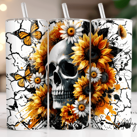 Three tumblers with skull and floral design on a blurred background