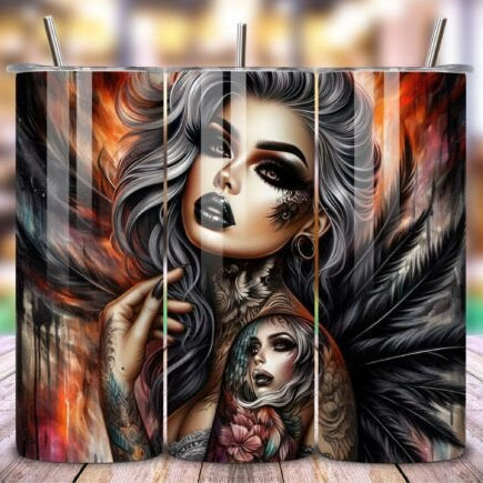 Candle with artistic design of a woman's face and feathers on a wooden surface.