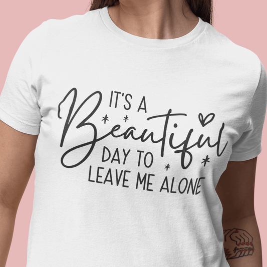 Person wearing a white t-shirt with a humorous quote on a pink background