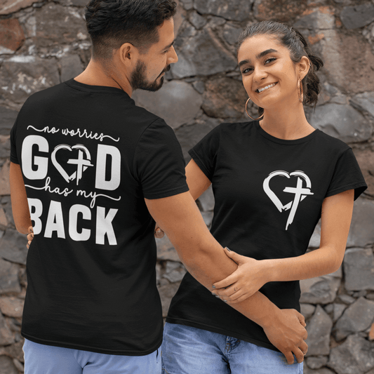 Two people wearing black t-shirts with a design and text, standing against a stone wall.