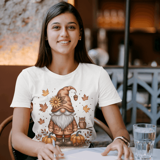 Woman wearing a white t-shirt with a gnomes and pumpkins design in a casual setting.