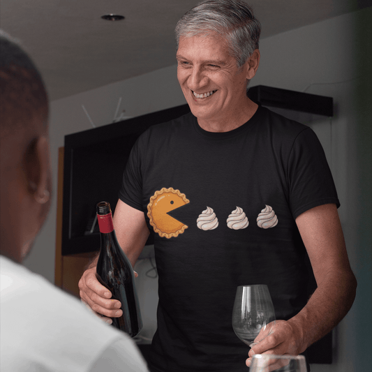 Man in a black t-shirt with a graphic design, holding a bottle and glass, standing next to a roasted turkey.
