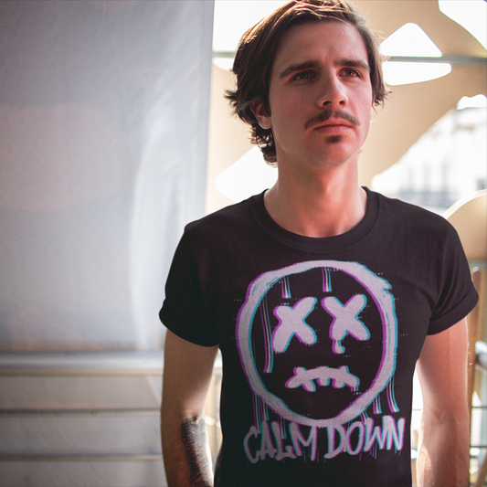 Man wearing a black t-shirt with a graphic design and text indoors.