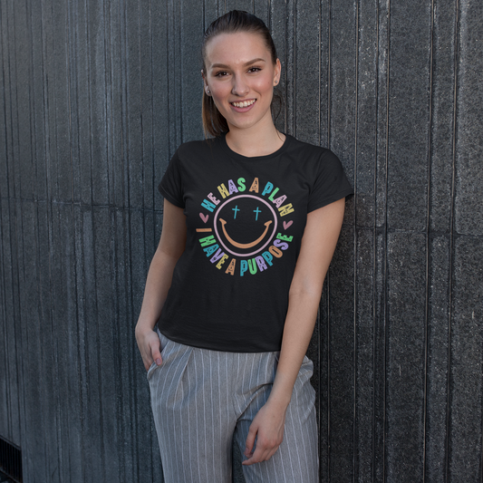 Woman wearing a black t-shirt with colorful design against a dark wooden wall.
