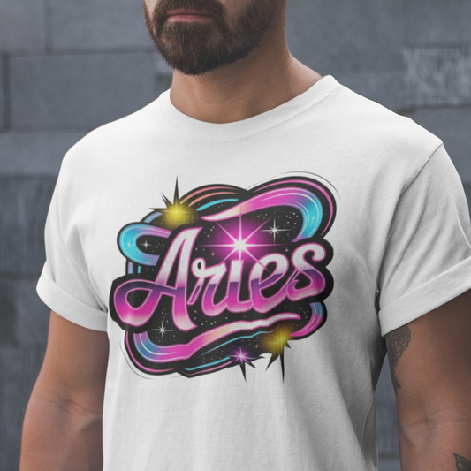 Person wearing a white t-shirt with 'Aries' design against a gray stone wall.