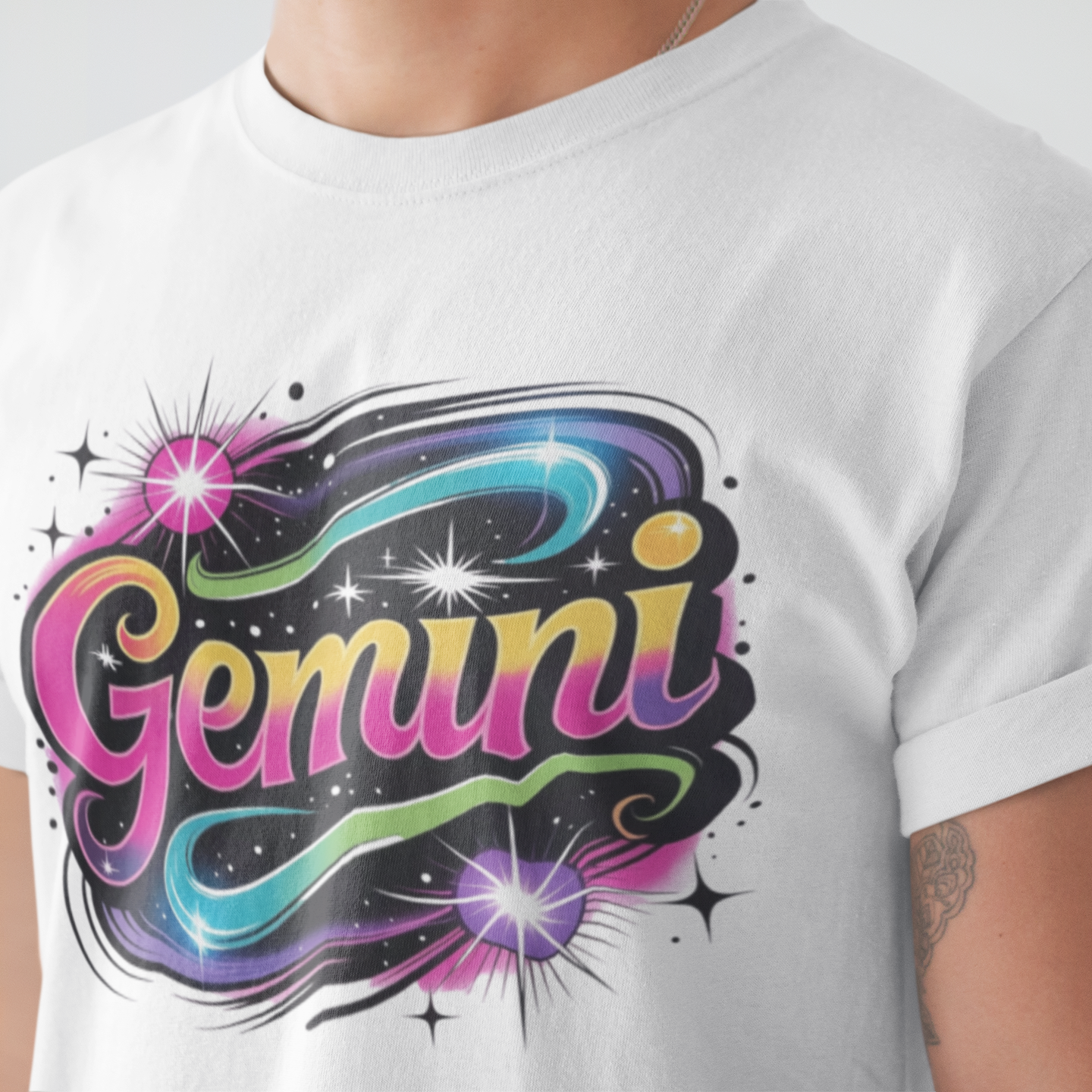 White t-shirt with 'Gemini' design featuring colorful letters on a plain background