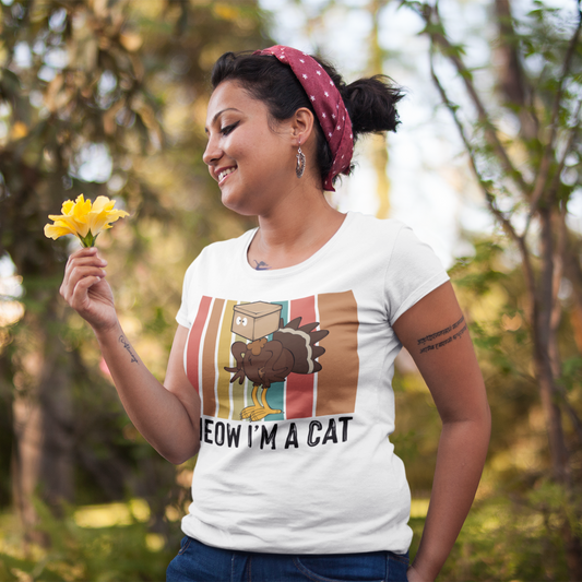 Woman holding flowers outdoors wearing a t-shirt with a graphic design.