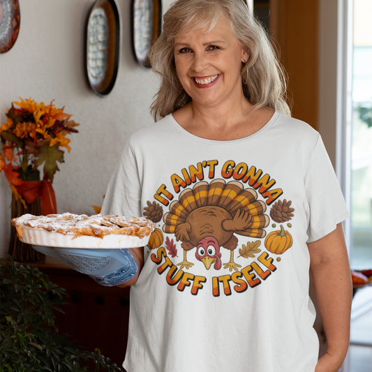 Woman wearing a white t-shirt with a Thanksgiving graphic, holding a pie.