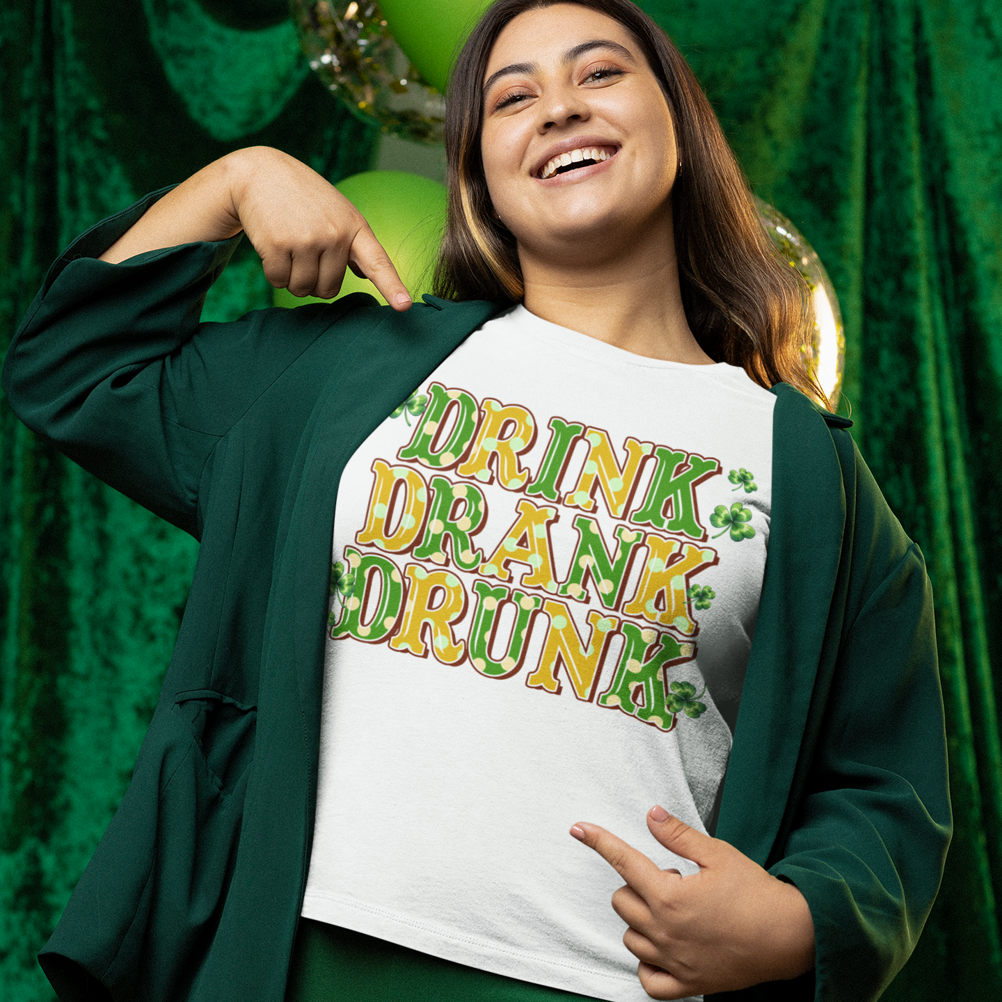 Person wearing a white t-shirt with 'Drink Drone Drunk' text in front of green curtains.