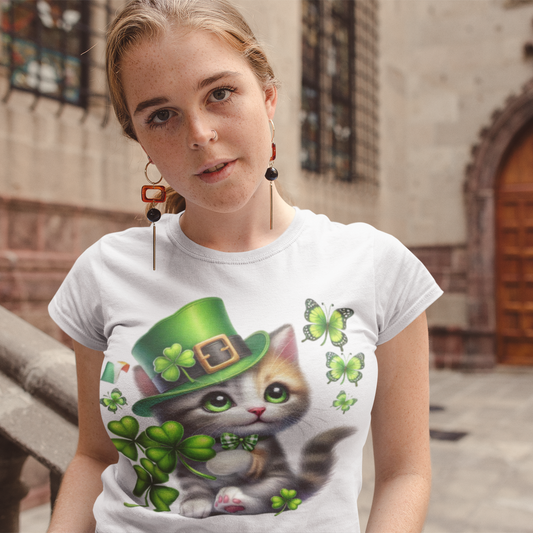 Person wearing a white t-shirt with a colorful graphic of a cat in a green hat and butterflies.