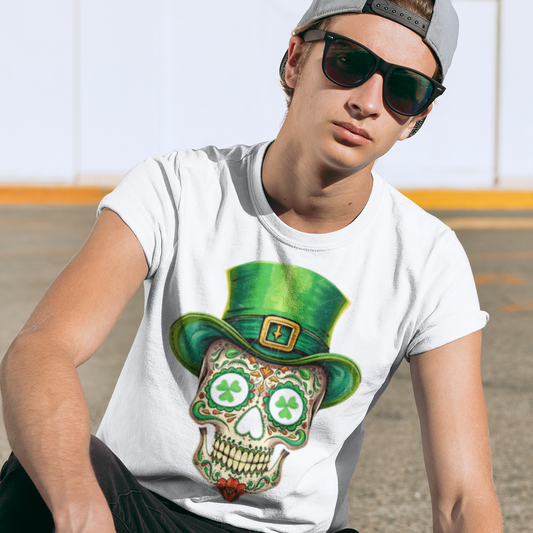 Person wearing a white t-shirt with a colorful skull design and green hat, sitting outdoors.